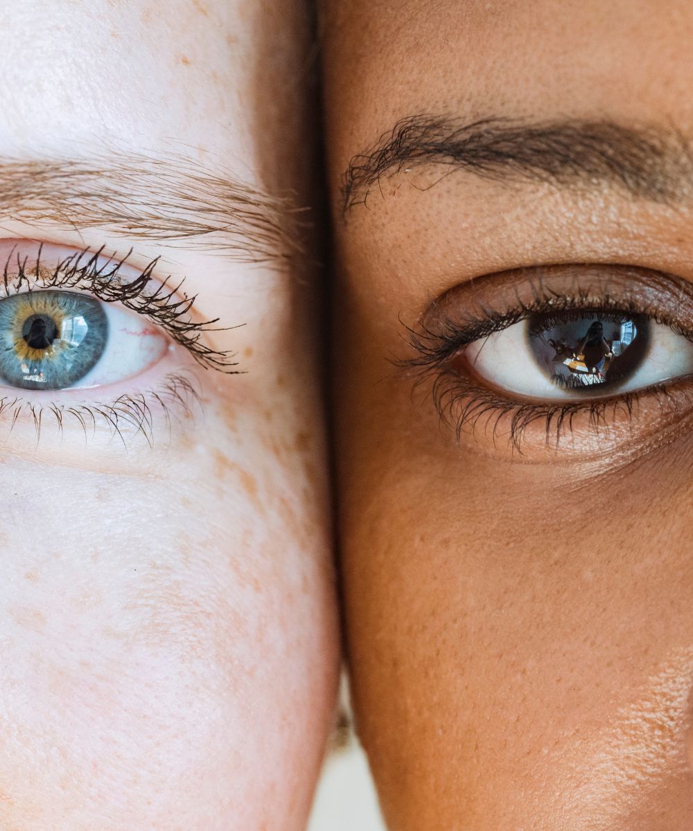 Close-up of two women's eyes, showcasing diversity and unity.