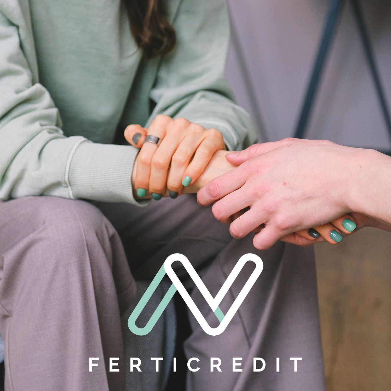 Close-up of two people holding hands with the FertiCredit logo, symbolizing financial support for egg freezing services through FertiCredit.