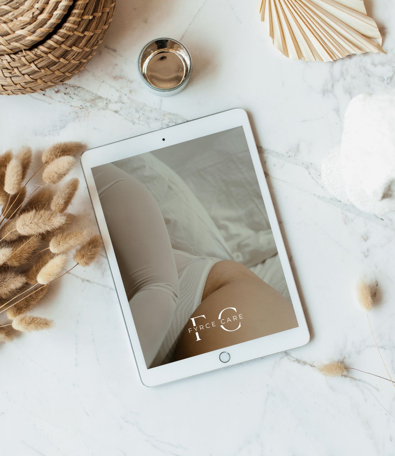 Tablet with pampas grass in the background, displaying the text: Your Guide to Egg Freezing – Request your free guide now.