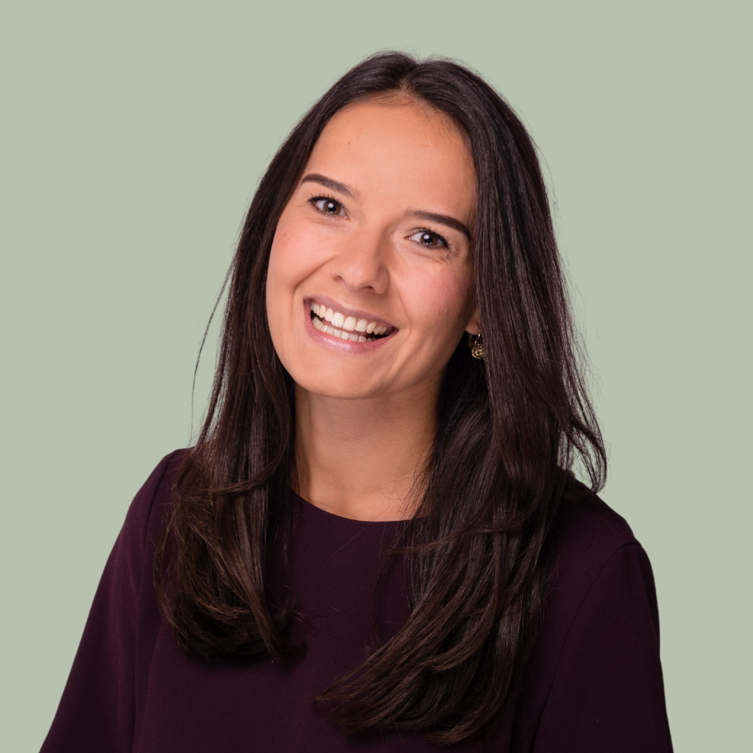 Lisa Maria Ladner, co-founder of Fyrce Care, smiling warmly in front of a green background