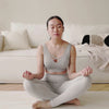 Video of a woman meditating, with the text: Get the most out of it – Personalized content to support your egg freezing journey.