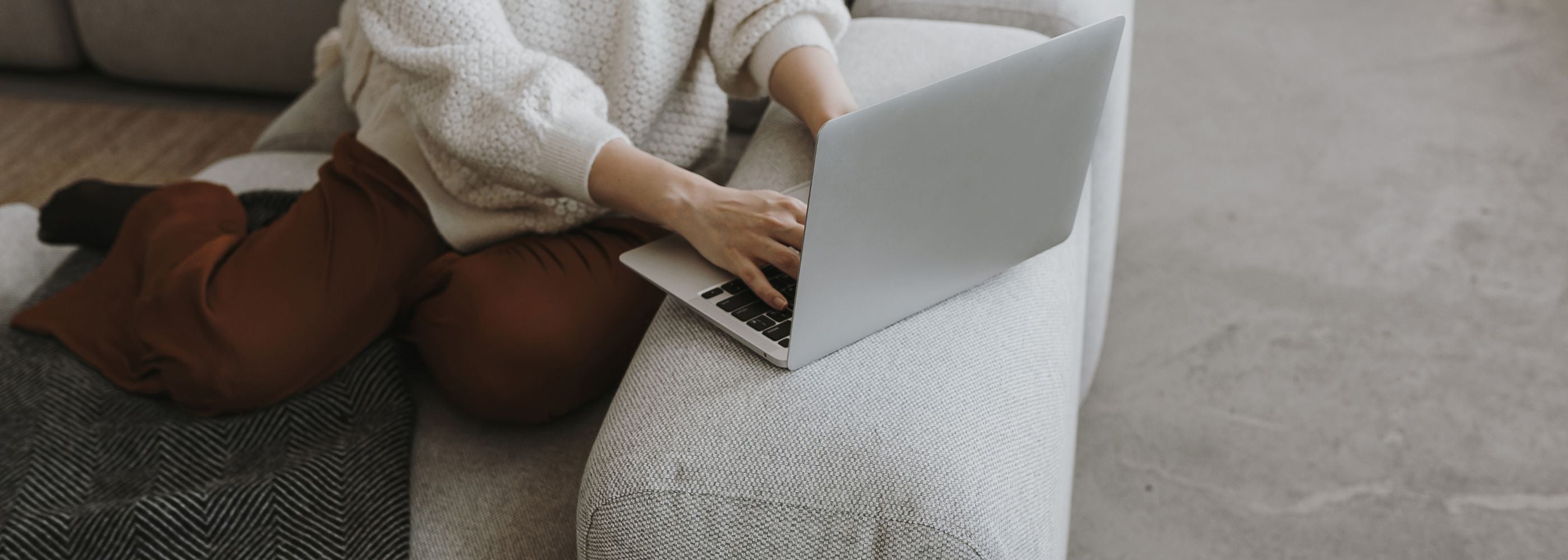 Woman at a laptop, filling out a contact form on the Fyrce Care website.